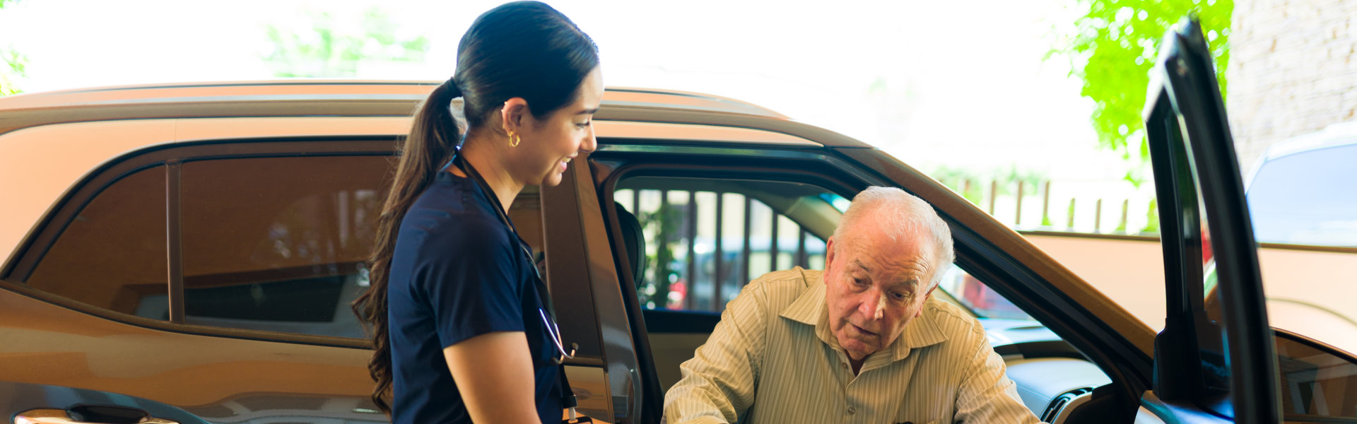 Nurse helping man to go outside the car.